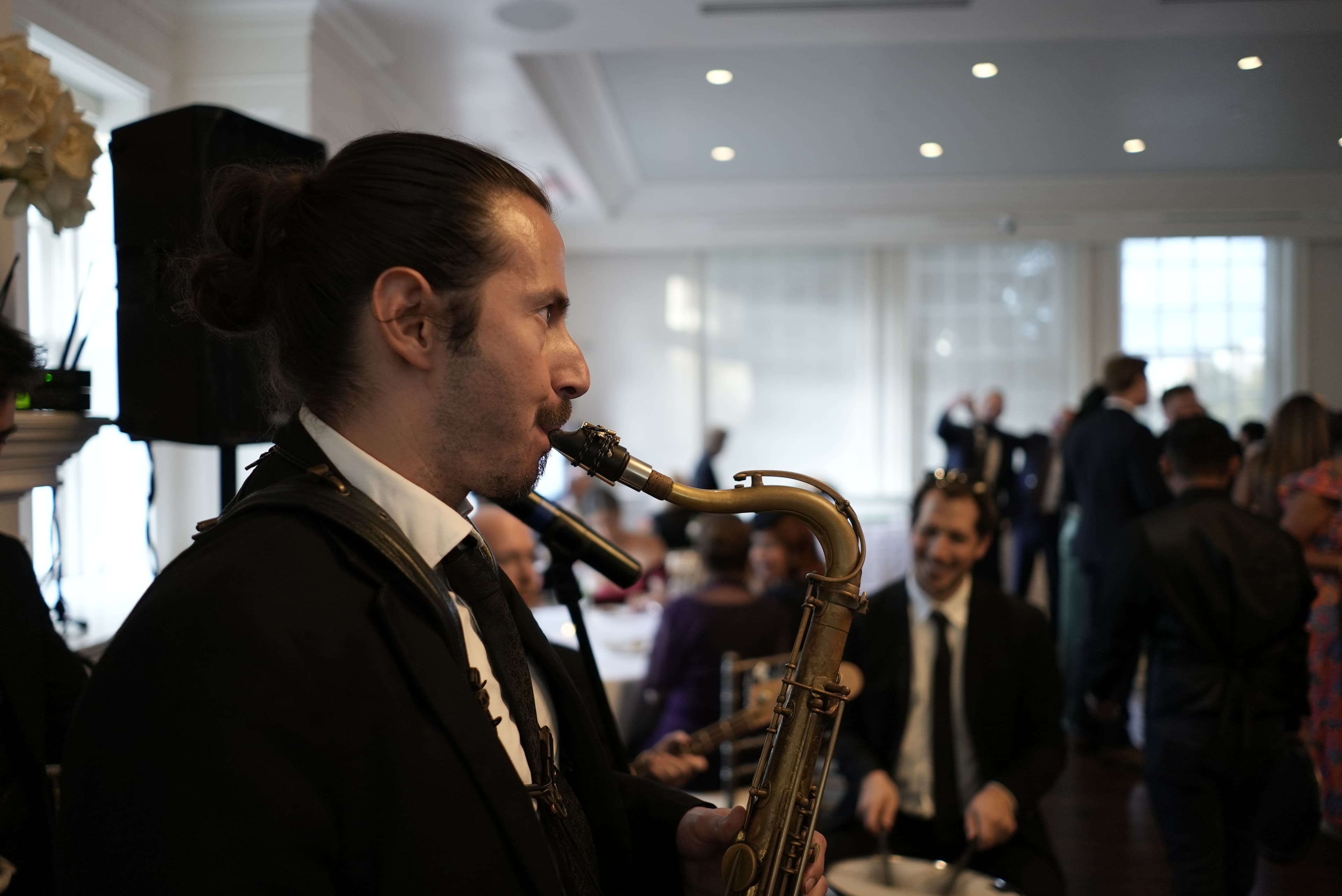 A Shuk saxophonist playing during a wedding ceremony